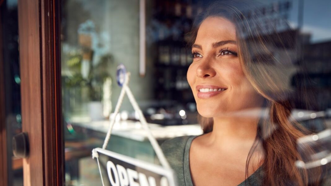 franchising represented by a smiling shop owner opening her store for the day