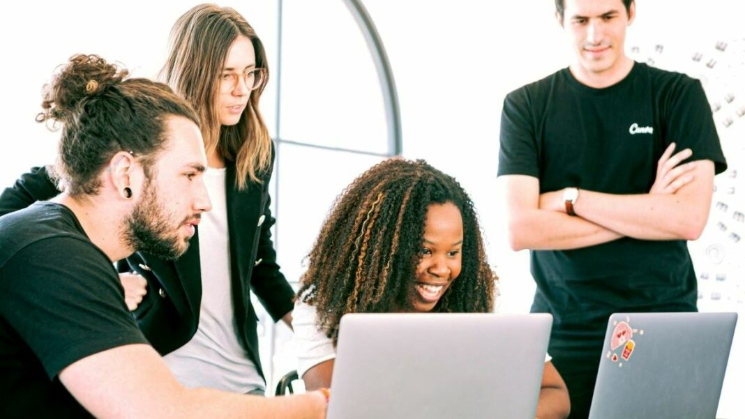 startup team members viewing a presentation on a laptop