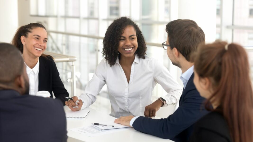 Work Opportunity Tax Credit represented by a diverse group of individuals sitting around a work conference table